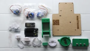 Componentes del kit brazo robótico con ESP32 — incluye servomotores, potenciómetros, base 3D y placa controladora listos para ensamblar.